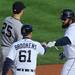 Tigers' Prince Fielder fist bumps first base coach Tom Brookens after hitting a singlein the first inning during Game 4 of the ALCS against the Yankees at Comerica Park in Detroit on Thursday. 